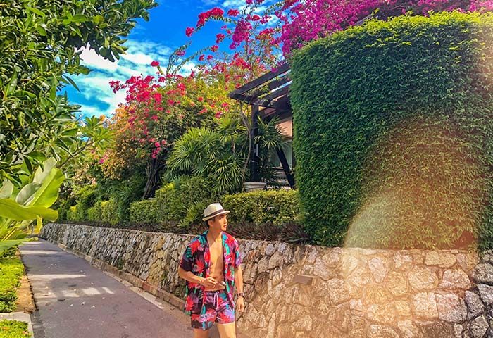 Gay man at Pullman Phuket Panwa Beach Resort, a SHA-certified gay-friendly hotel. Lush tropical landscape, perfect for LGBT travel.