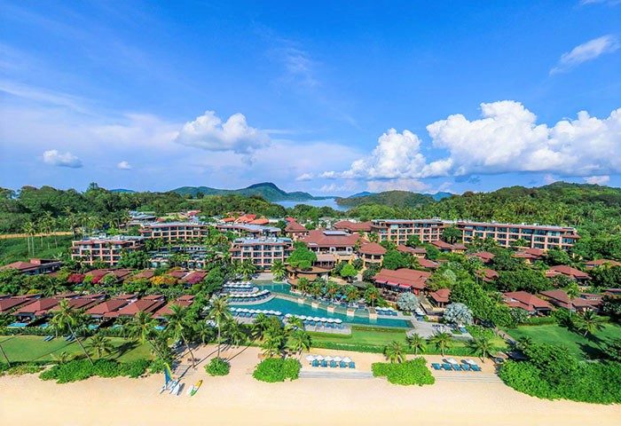 Aerial view of Pullman Phuket Panwa Beach Resort, a SHA-certified gay-friendly hotel. Lush greenery, pool, and beach visible.