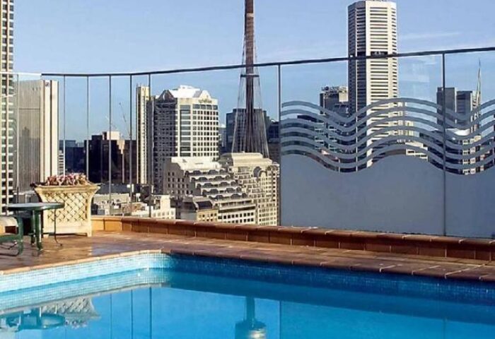 Rooftop pool at gay-friendly Pullman Sydney Hyde Park Hotel. Sydney skyline view from this gay travel accommodation.