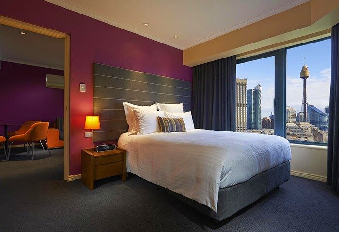 Pullman Sydney Hyde Park gay-friendly hotel room with city view. Modern design, comfortable bed, and vibrant colors. Ideal for gay travelers.