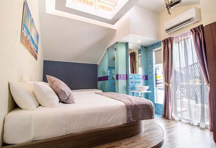 Q Loft Hotel1929@Chinatown room. Gay-friendly hotel bedroom with modern design, bed, bathroom, and balcony. Chinatown travel advice.