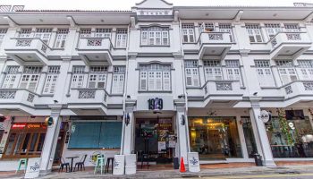Q Loft Hotel 1929@Chinatown facade. This gay-friendly hotel in Singapore features a vintage design with balconies and shuttered windows.