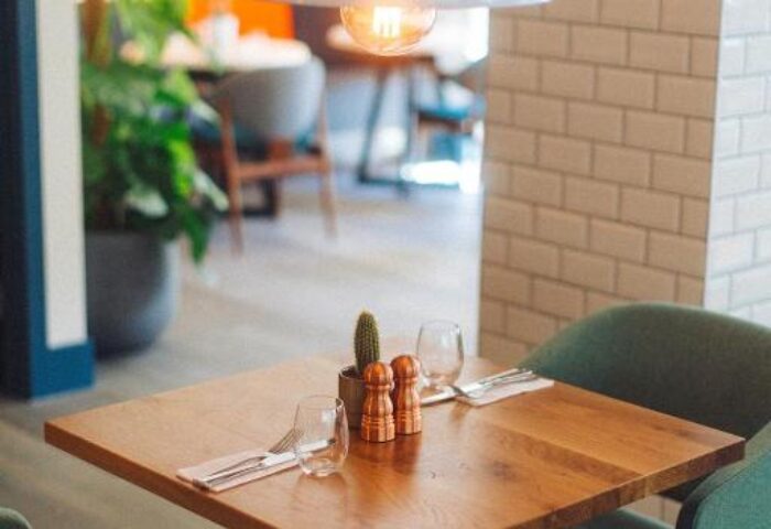 Qbic London City hotel dining area. Table set for two with cactus centerpiece. Gay-friendly, pet-friendly hotel in London.