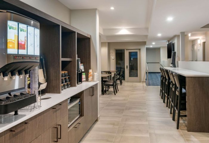 Quality Inn Centre-Ville's gay-friendly hotel breakfast bar. Juice dispenser, microwave, coffee, seating. Perfect for gay travelers.