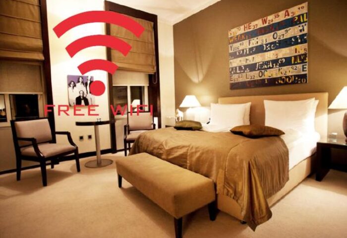 Quentin Design Hotel Berlin room with free WiFi. Gay-friendly hotel featuring a bed, chairs, and a unique license plate art piece.
