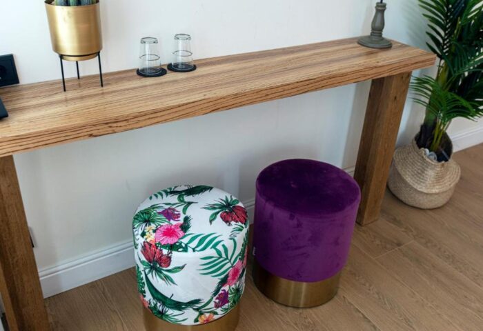 Quentin Golden Bear Hotel detail. A gay-friendly hotel room interior with a table, stools, and plants. Modern decor, travel advice.