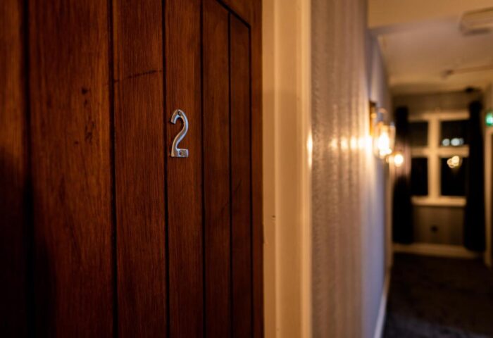 REM Hotel room door with number 2. Gay-friendly hotel interior with a focus on design and comfort for gay travelers.