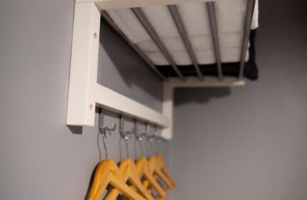 REM Hotel's closet. A gay-friendly hotel featuring a shelf with towels and hangers for clothes. Perfect for gay travel and LGBTQ+ vacations.