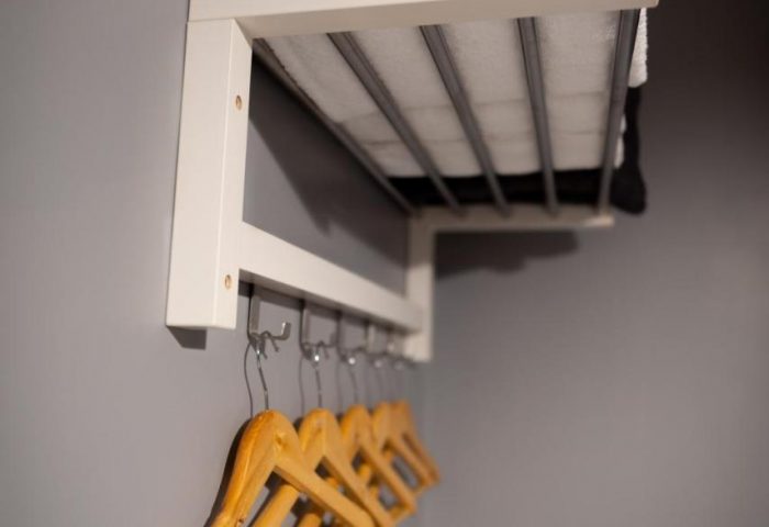 REM Hotel's closet. A gay-friendly hotel featuring a shelf with towels and hangers for clothes. Perfect for gay travel and LGBTQ+ vacations.