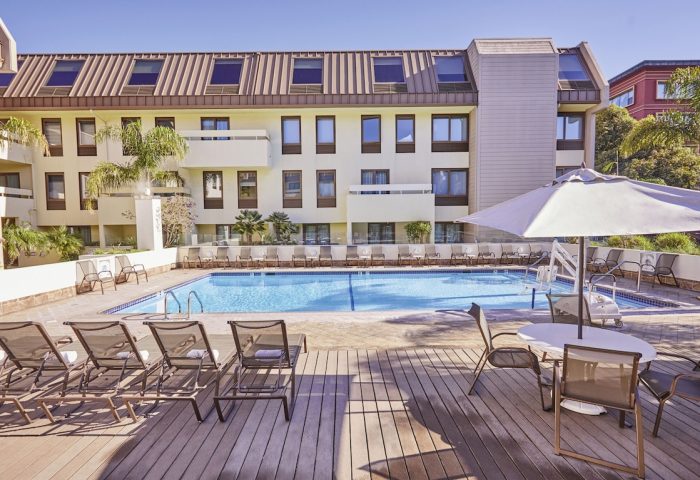 RIU Plaza Fisherman's Wharf gay-friendly hotel pool. Lounge chairs and tables surround the pool. A great place to relax in San Francisco.