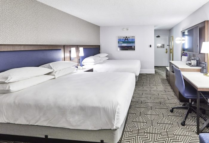RIU Plaza Fisherman's Wharf gay-friendly hotel room. Two beds, desk, and TV. Modern decor. A great place for gay men to stay in San Francisco.