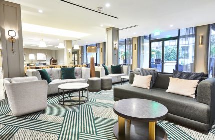 Lobby at the gay-friendly RIU Plaza Fisherman's Wharf hotel. Modern design with couches, chairs, and tables. A great place for gay travelers.