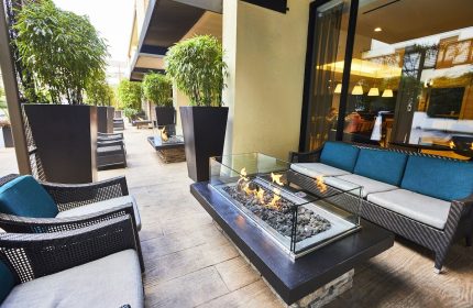 RIU Plaza Fisherman's Wharf gay-friendly hotel outdoor patio. Fire pit, seating, and plants create a relaxing ambiance for gay travelers.