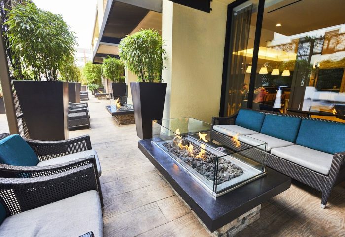 RIU Plaza Fisherman's Wharf gay-friendly hotel outdoor patio. Fire pit, seating, and plants create a relaxing ambiance for gay travelers.