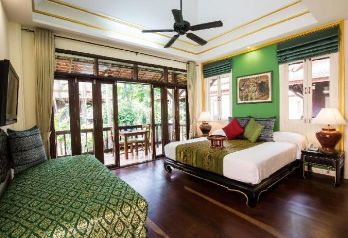 Rabbit Resort gay-friendly hotel room. Bed, daybed, balcony, ceiling fan, and green walls. A relaxing space for gay men's travel in Thailand.