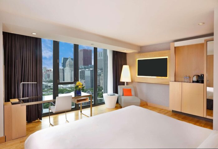 Radisson Blu Aqua Hotel, Chicago guest room. Gay-friendly hotel with city view, desk, chair, and bed. Modern design for gay travelers.