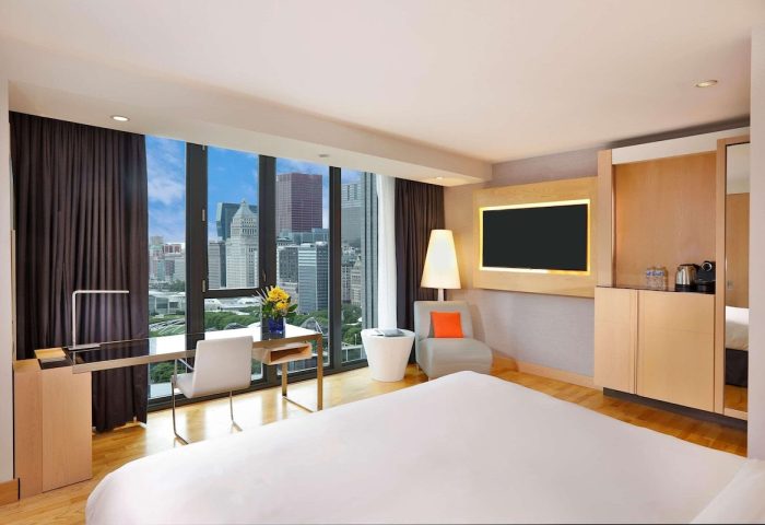 Radisson Blu Aqua Hotel, Chicago guest room. Gay-friendly hotel with city view, desk, chair, and bed. Modern design for gay travelers.