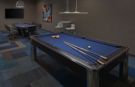 Radisson Blu Aqua Hotel, Chicago game room with pool table and poker table. A gay-friendly hotel amenity for entertainment.