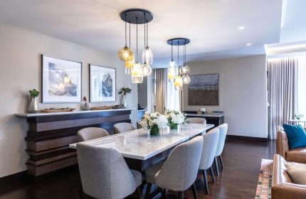 Dining area at Radisson Blu Aqua Hotel, Chicago. Gay-friendly hotel with modern decor, marble table, and stylish lighting. Luxury travel.