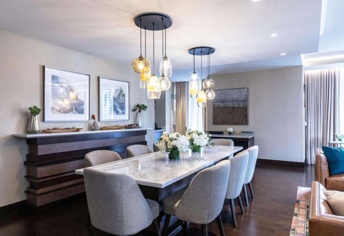 Dining area at Radisson Blu Aqua Hotel, Chicago. Gay-friendly hotel with modern decor, marble table, and stylish lighting. Luxury travel.