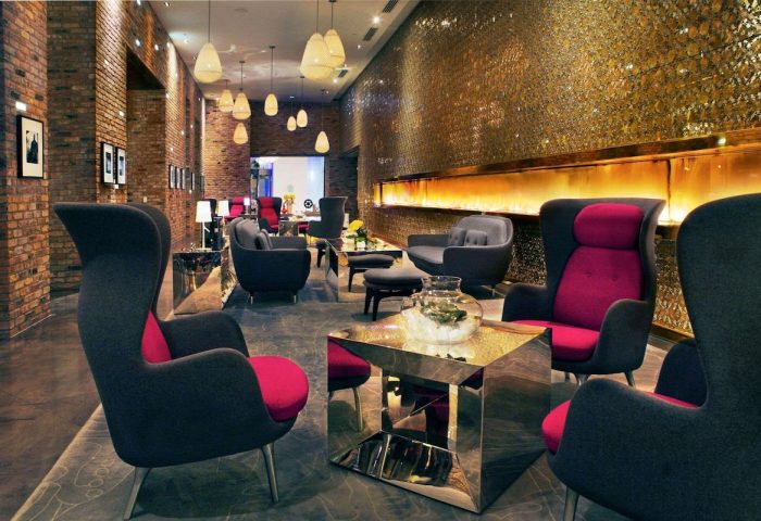 Radisson Blu Aqua Hotel, Chicago: Chic lobby lounge area. Gay-friendly hotel with stylish seating, modern design, and warm lighting.