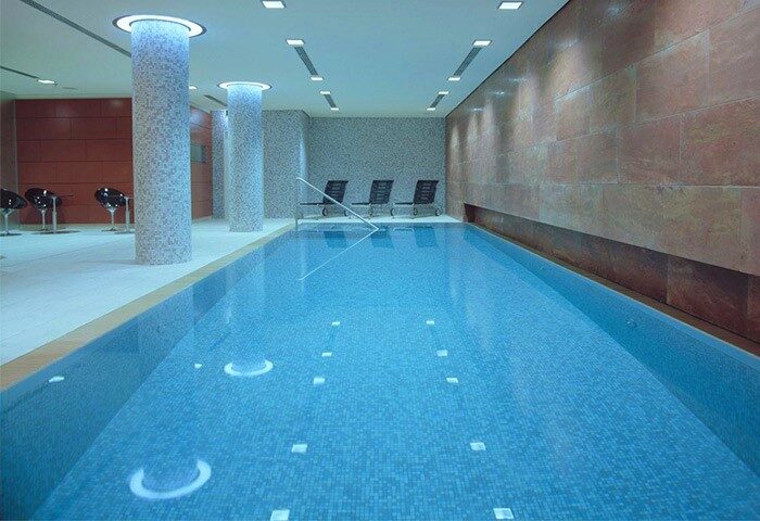 Indoor pool at Radisson Collection Hotel, Berlin. Gay-friendly hotel with swimming pool for gay men travelers. Radisson Blu Hotel Berlin.