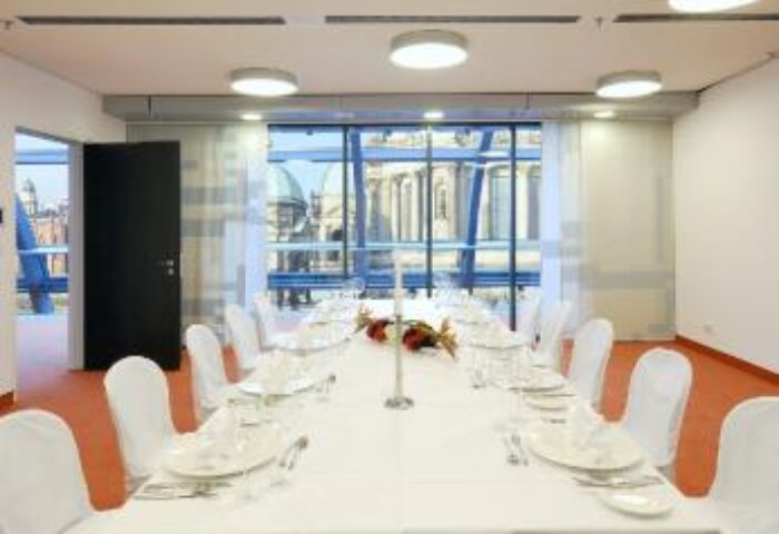 Radisson Collection Hotel, Berlin meeting room. Long table set for a formal event. Gay-friendly hotel with city view. Radisson Blu Hotel Berlin.