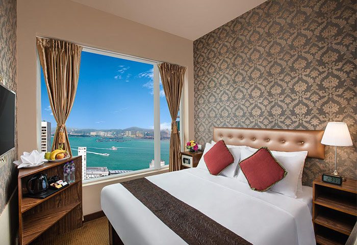 Ramada Hong Kong Harbour View hotel room. A gay-friendly hotel featuring a bed, harbour view, and modern decor. Ideal for gay travelers.