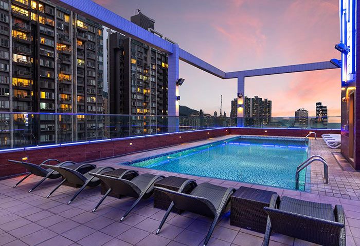 Rooftop pool at the gay-friendly Ramada Hong Kong Harbour View hotel. City skyline views, lounge chairs, and tranquil atmosphere. Perfect for gay travelers.