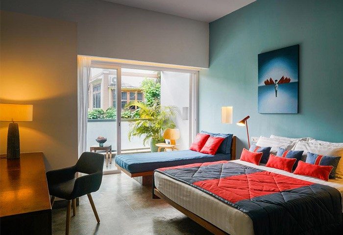 Rambutan Resort, Phnom Penh: Gay-friendly hotel room with double bed, daybed, desk, and balcony. Modern design, comfortable stay.
