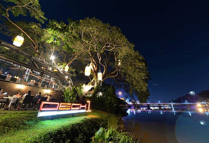 RarinJinda Wellness Spa Resort gay-friendly hotel at night. Deck 1 restaurant with river view. Chiang Mai travel for gay men.