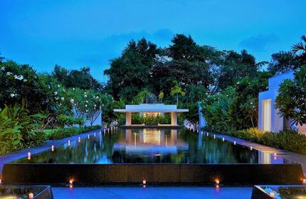 Rayong Marriott Resort & Spa, a gay-friendly hotel. Reflecting pool with candles at dusk. Serene and inviting for gay travelers.