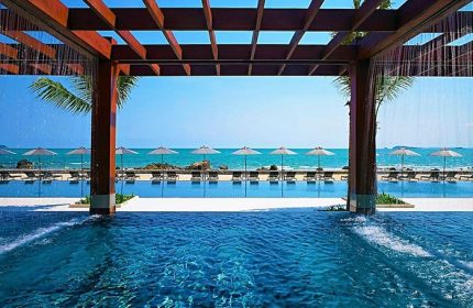 Rayong Marriott Resort & Spa pool view. Gay-friendly hotel with beach access, umbrellas, and lounge chairs. Perfect for gay travel.