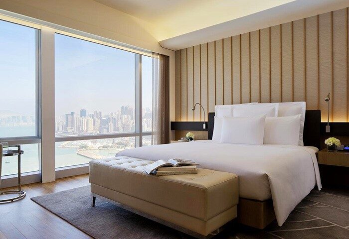Renaissance Hong Kong Harbour View Hotel room. Gay-friendly hotel with harbor view. Modern design, large windows, and comfortable bed.