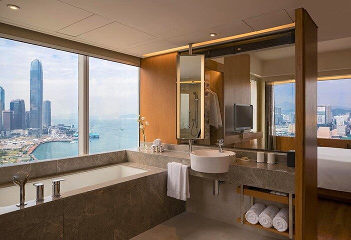 Renaissance Hong Kong Harbour View Hotel bathroom. Harbor view from the bathtub. Gay-friendly hotel with modern amenities. City skyline.