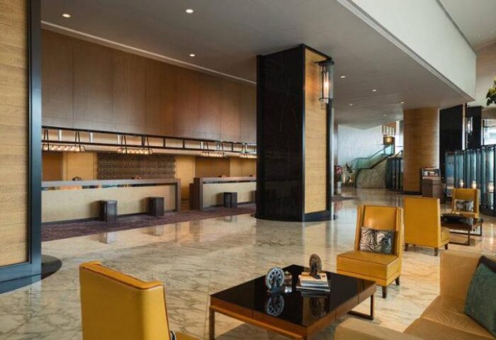 Renaissance Hong Kong Harbour View Hotel lobby. Gay-friendly hotel with modern design, seating area, and reception. Ideal for gay travelers' comfort.