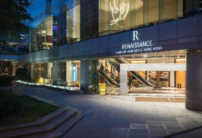 Renaissance Hong Kong Harbour View Hotel entrance. Gay-friendly hotel with modern architecture and escalators. Luxury travel destination.