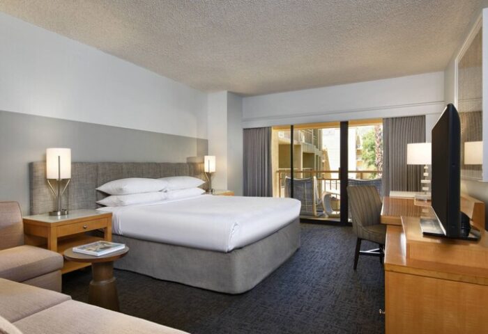 Gay-friendly Renaissance Palm Springs Hotel room. King bed, balcony, desk, and TV. A great stay in Palm Springs for gay men travelers.
