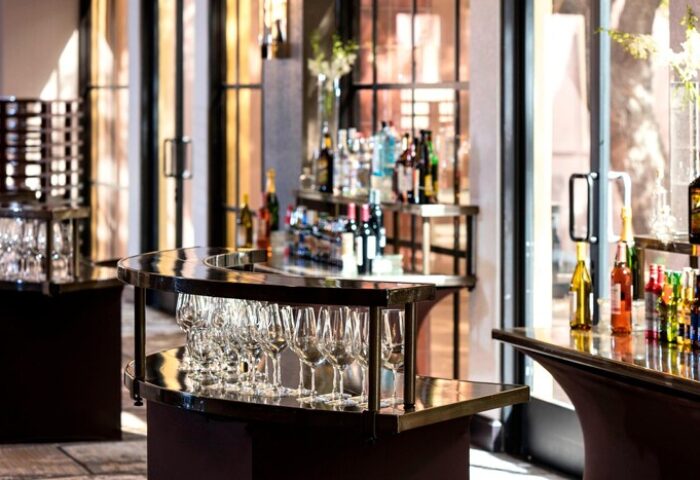 Bar setup at Renaissance Palm Springs Hotel, a gay-friendly hotel. Glasses, bottles, and drinks are displayed, ready for guests.