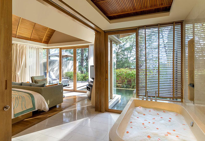 Gay-Friendly Renaissance Phuket Resort & Spa suite. Bathtub, bedroom, and outdoor patio. Luxury gay travel in Thailand.