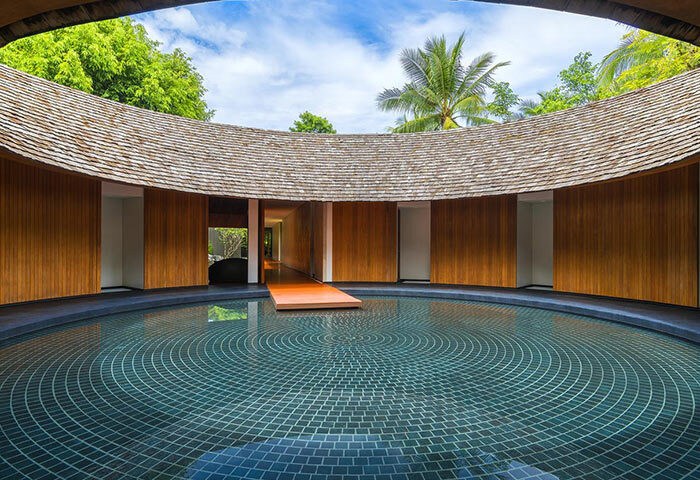 Renaissance Phuket Resort & Spa's unique architecture. Circular pool, wood panels, and open roof. Gay-friendly hotel for a relaxing getaway.