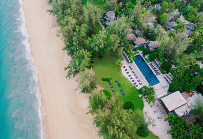 Aerial view of gay-friendly Renaissance Phuket Resort & Spa. Beachfront property with pool, lush greenery. Ideal for gay travel.
