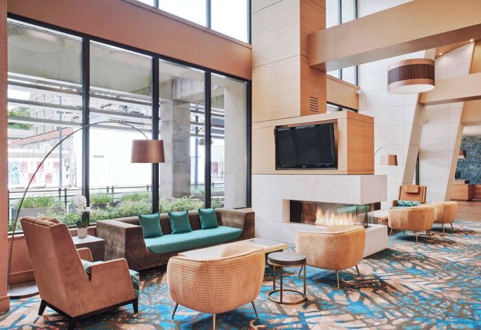 Residence Inn by Marriott Vancouver Downtown lobby. Modern, gay-friendly hotel with fireplace, TV, and comfortable seating.