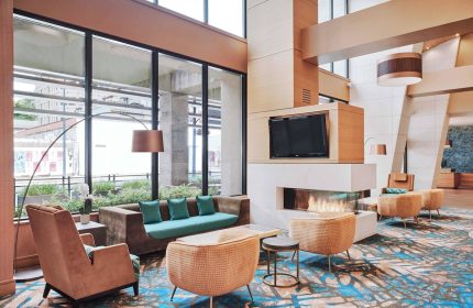 Residence Inn by Marriott Vancouver Downtown lobby. Modern, gay-friendly hotel with fireplace, TV, and comfortable seating.