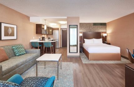 Residence Inn by Marriott Vancouver Downtown suite. Gay-friendly hotel with bed, sofa, kitchen, and modern decor. Perfect for gay travel.