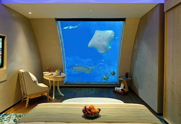 Resorts World Sentosa Beach Villas gay-friendly hotel room. Underwater view with manta rays, fish. SG Clean Certified resort bedroom.