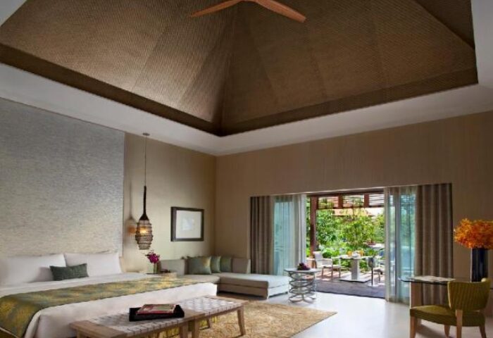 Resorts World Sentosa Beach Villas bedroom. Gay-friendly hotel with outdoor patio. SG Clean Certified. Luxury travel in Singapore.
