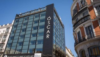 Room Mate Oscar Hotel, a gay-friendly hotel in Madrid. Modern architecture with the hotel's name vertically displayed. Great for gay travel.