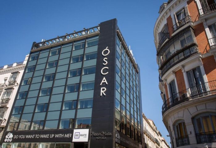 Room Mate Oscar Hotel, a gay-friendly hotel in Madrid. Modern architecture with the hotel's name vertically displayed. Great for gay travel.