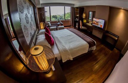 Rose Garden Hotel room: Gay-friendly hotel featuring a king-size bed, desk, TV, and a view. Ideal for gay men's travel and relaxation.